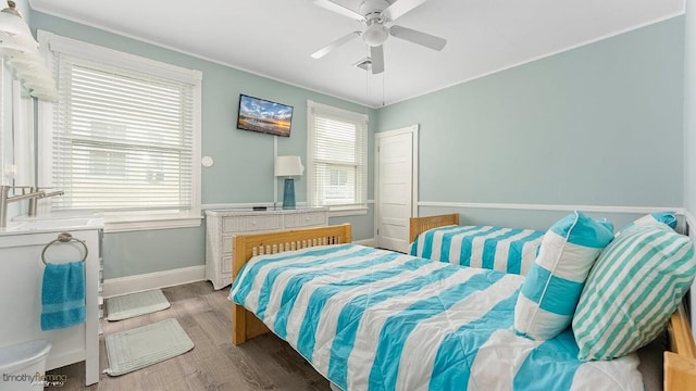 bedroom featuring hardwood / wood-style flooring and ceiling fan