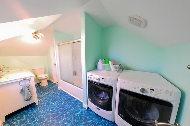 washroom with sink and washer and clothes dryer