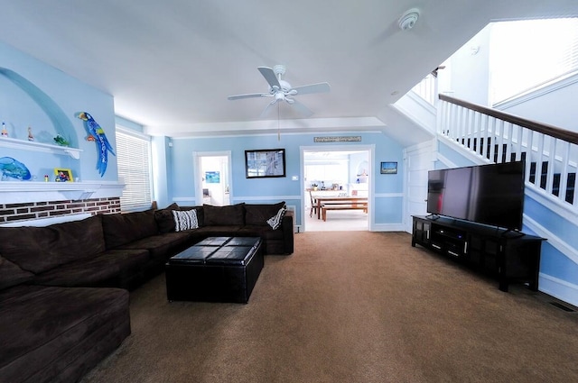 carpeted living room with ceiling fan