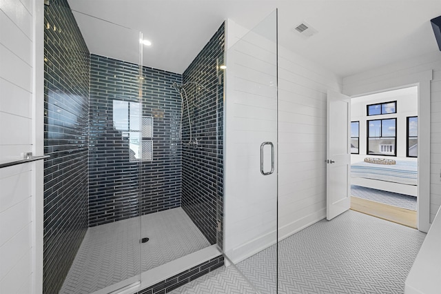 bathroom with tile patterned floors and a shower with shower door