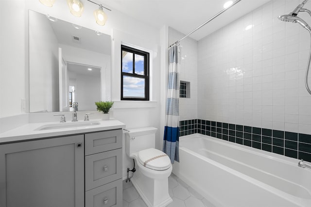 full bathroom featuring tile patterned flooring, vanity, toilet, and shower / tub combo