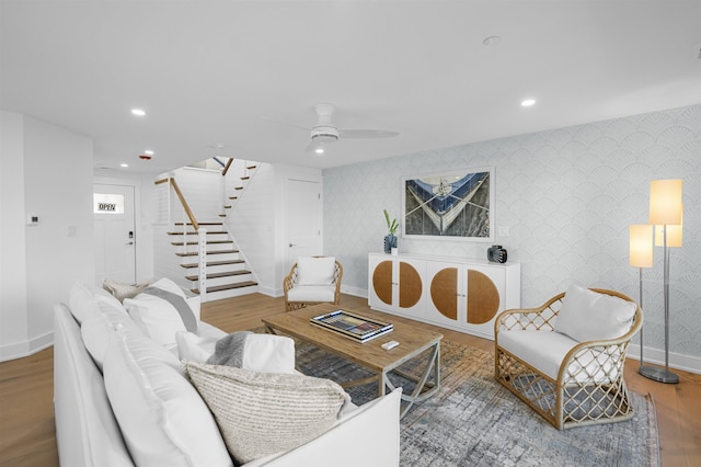 living room featuring ceiling fan and hardwood / wood-style flooring