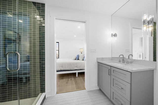 bathroom featuring tile patterned flooring, vanity, and an enclosed shower