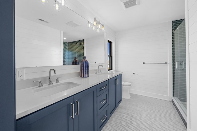 bathroom with tile patterned floors, vanity, toilet, and walk in shower