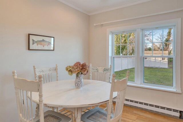 717 Third Ave, West Cape May, NJ 08204 - dining room with baseboard heating, ornamental molding, and light wood finished floors