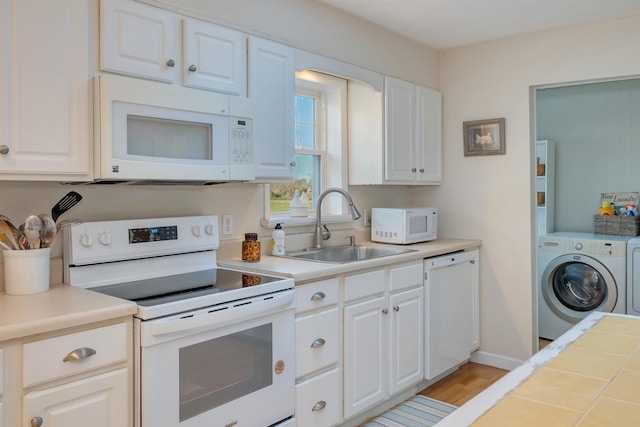 717 Third Ave, West Cape May, NJ 08204 - kitchen with white appliances, washer / dryer, light countertops, and white cabinets