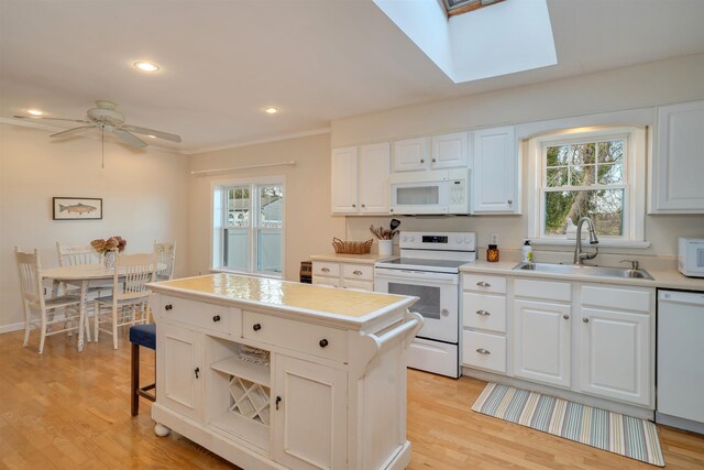 717 Third Ave, West Cape May, NJ 08204 - kitchen with white appliances, a skylight, healthy amount of natural light, light countertops, and recessed lighting