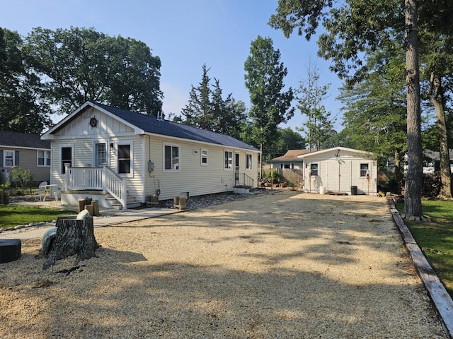 704 E Tampa Ave, Villas, NJ 08251 - back of house with board and batten siding, a shed, and driveway