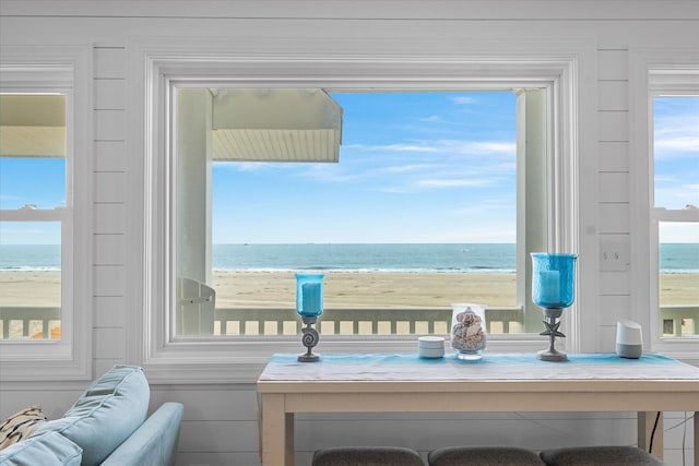 interior space featuring a beach view and a water view