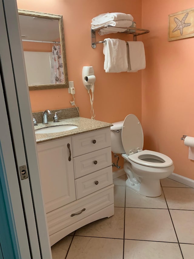 bathroom with tile patterned floors, vanity, and toilet