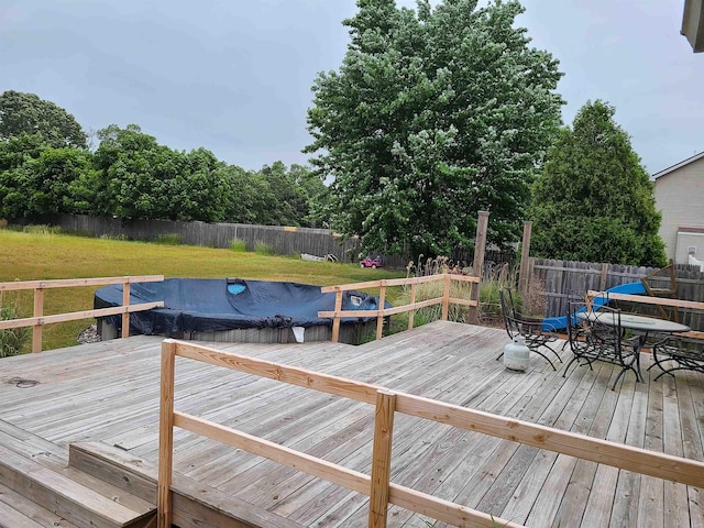 dock area with a yard and a deck