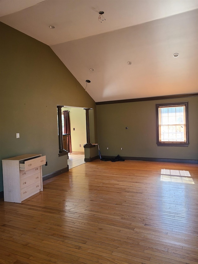 spare room with lofted ceiling and light wood-type flooring