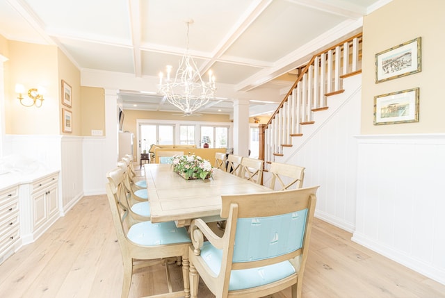 dining space with ornate columns, coffered ceiling, and light hardwood / wood-style flooring