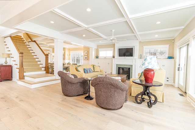 living room featuring coffered ceiling, ornate columns, ceiling fan, beam ceiling, and light hardwood / wood-style floors