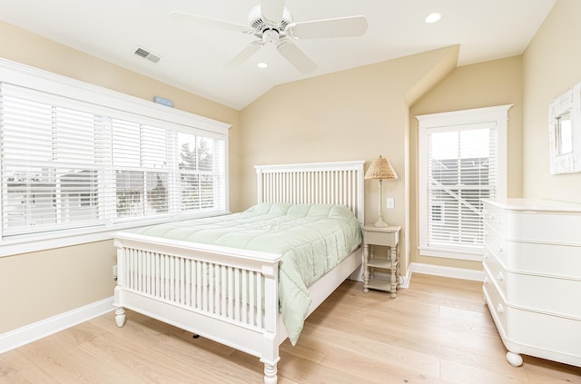 bedroom with light hardwood / wood-style flooring, ceiling fan, and vaulted ceiling