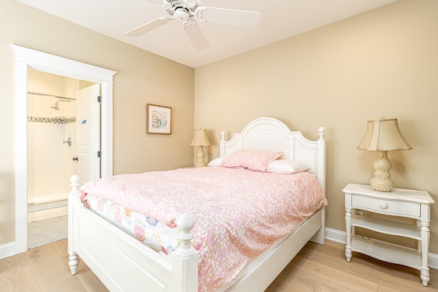 bedroom with connected bathroom, ceiling fan, and light wood-type flooring