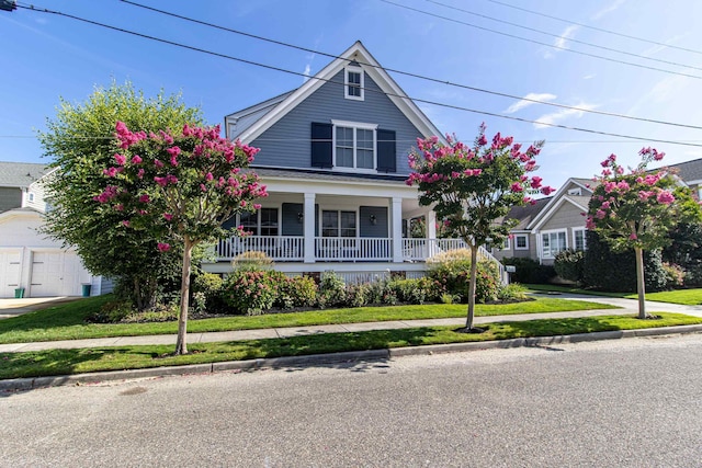 view of front of house with a front yard and covered porch