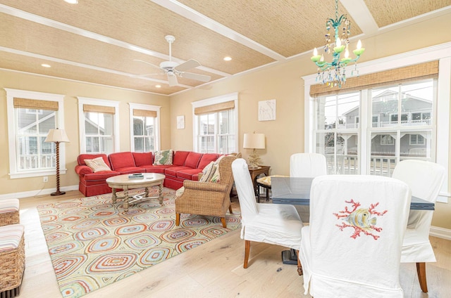 living room featuring ceiling fan with notable chandelier, beam ceiling, and light hardwood / wood-style flooring