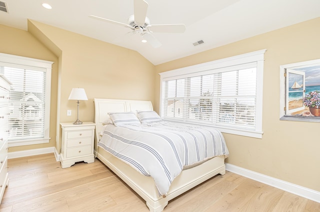 bedroom featuring ceiling fan, lofted ceiling, and light hardwood / wood-style flooring