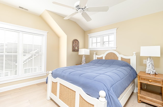 bedroom featuring ceiling fan, lofted ceiling, and light hardwood / wood-style flooring