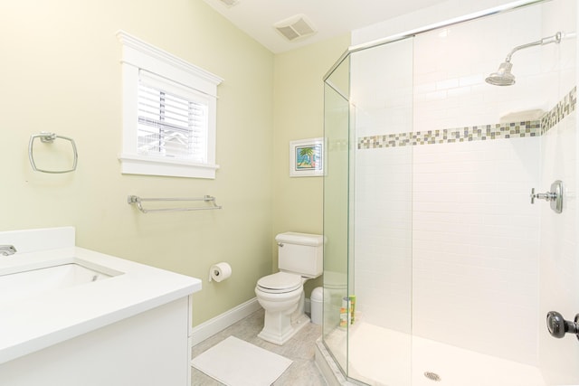 bathroom with tile patterned floors, vanity, toilet, and a shower with door