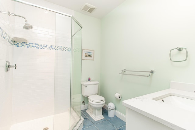 bathroom with tile patterned flooring, an enclosed shower, vanity, and toilet