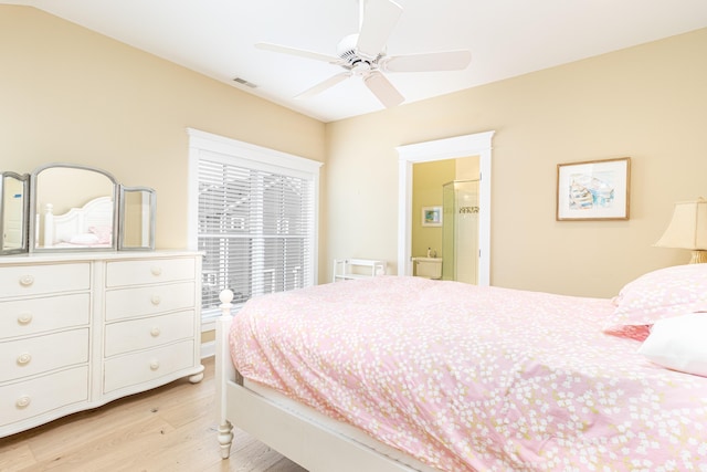 bedroom with ceiling fan, connected bathroom, and light hardwood / wood-style floors