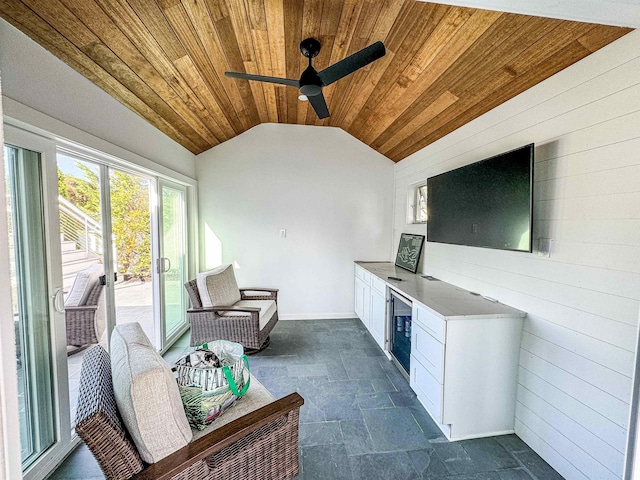 interior space featuring wine cooler, lofted ceiling, wood ceiling, wooden walls, and ceiling fan