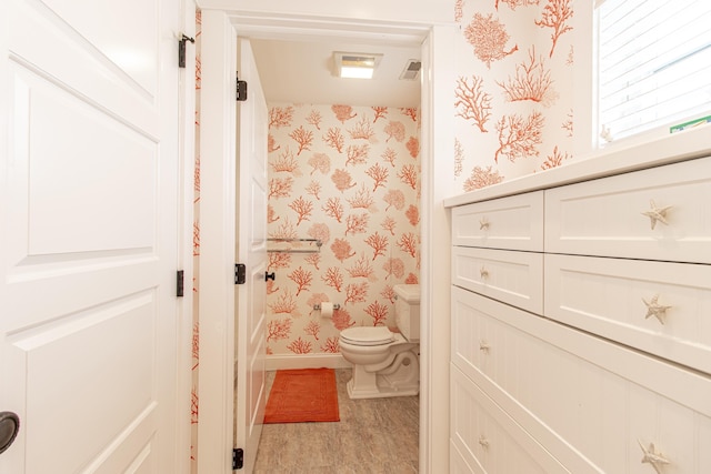 bathroom featuring hardwood / wood-style flooring and toilet