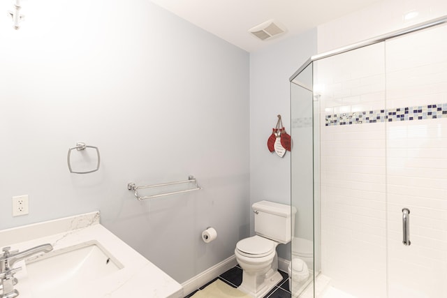 bathroom featuring vanity, an enclosed shower, tile patterned floors, and toilet