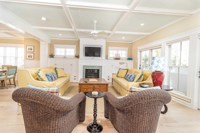 living room with beamed ceiling, coffered ceiling, ceiling fan, and light wood-type flooring