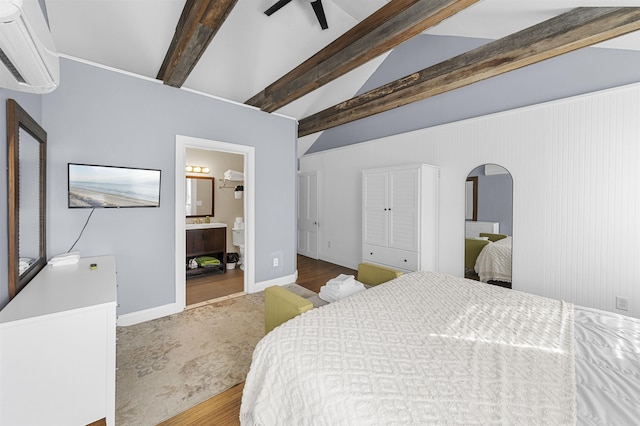 8281/2 Corgie St, Cape May, NJ 08204 - bedroom featuring an AC wall unit, arched walkways, wood finished floors, and connected bathroom