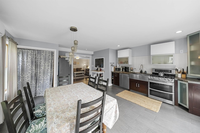 8281/2 Corgie St, Cape May, NJ 08204 - kitchen featuring stainless steel appliances, dark brown cabinetry, beverage cooler, recessed lighting, and glass insert cabinets