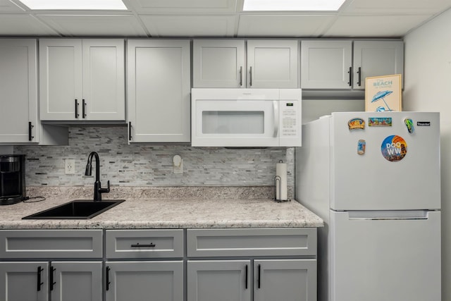 417 E 22nd Ave Unit 101, North Wildwood, NJ 08260 - kitchen with white appliances, gray cabinets, tasteful backsplash, and a drop ceiling