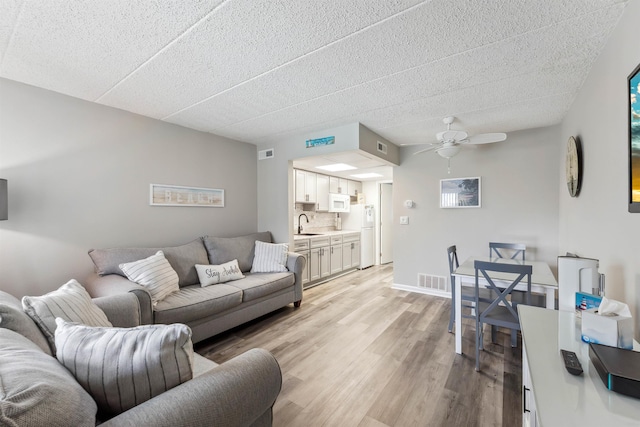 417 E 22nd Ave Unit 101, North Wildwood, NJ 08260 - living area with light wood finished floors and ceiling fan