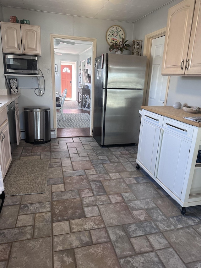 435 W Pine Ave, Wildwood, NJ 08260 - kitchen with stainless steel appliances, brick patterned floors, and a ceiling fan
