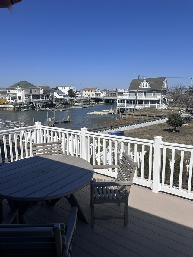 435 W Pine Ave, Wildwood, NJ 08260 - wooden terrace with a water view, outdoor dining area, and a dock