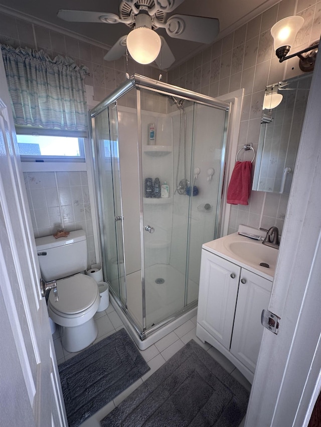 435 W Pine Ave, Wildwood, NJ 08260 - full bath featuring tile walls, tile patterned floors, a ceiling fan, vanity, and a shower stall