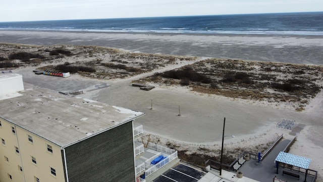 aerial view featuring a view of the beach and a water view