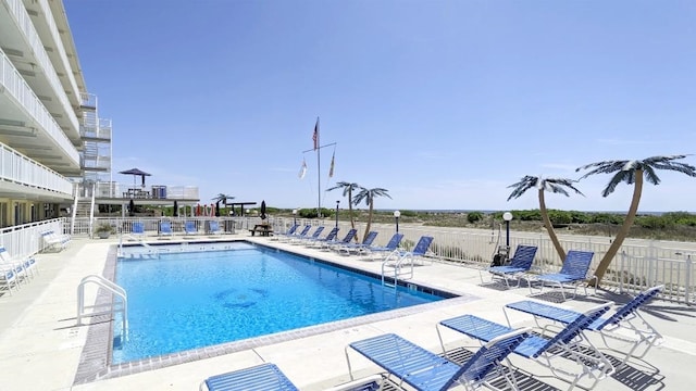 community pool featuring a patio area and fence