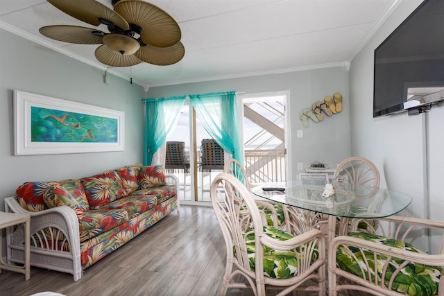 living room with ornamental molding, wood finished floors, and a ceiling fan