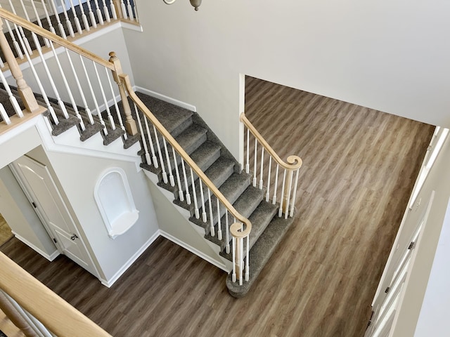 stairway with hardwood / wood-style floors