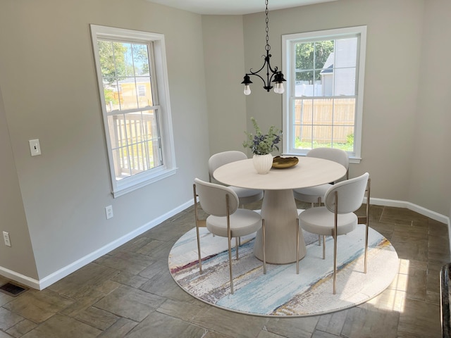 dining space featuring plenty of natural light and a chandelier