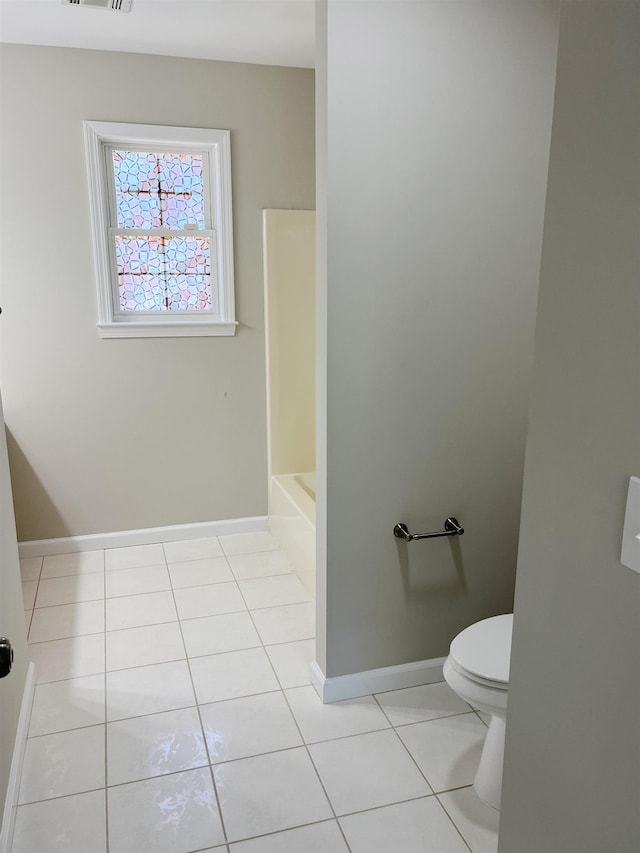 bathroom with tile patterned flooring and toilet