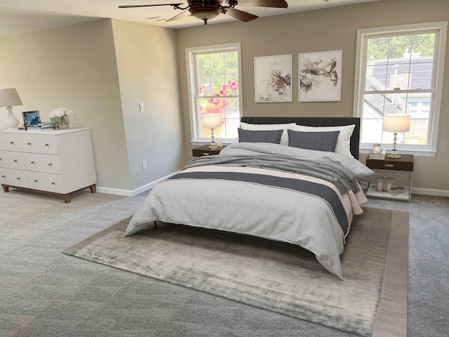 bedroom featuring light colored carpet and ceiling fan