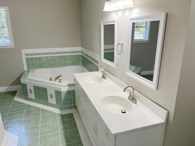 bathroom featuring tile patterned flooring, vanity, and a relaxing tiled tub