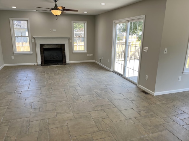 unfurnished living room featuring ceiling fan