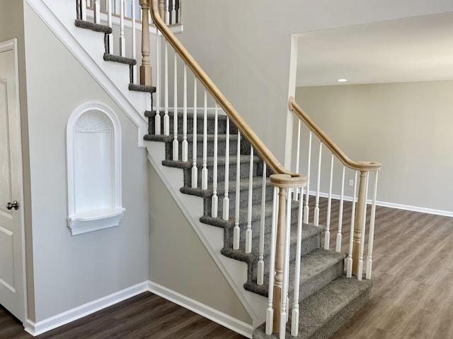 staircase with wood-type flooring