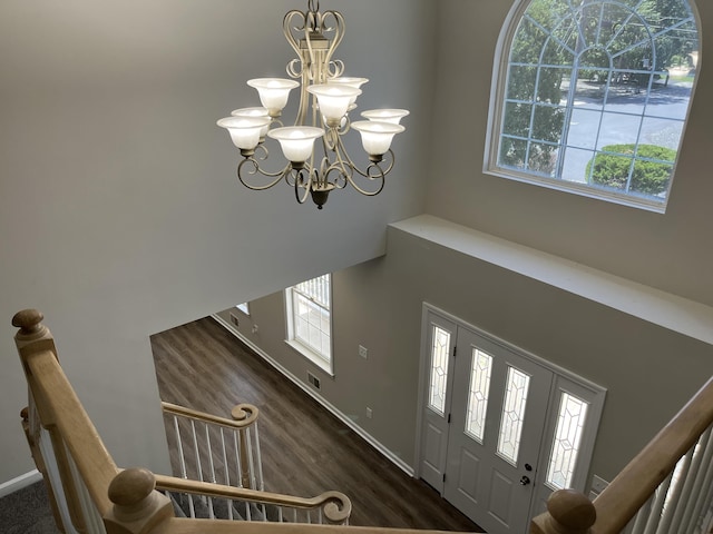 foyer entrance with a towering ceiling and an inviting chandelier