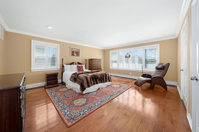 bedroom with light wood-type flooring and crown molding